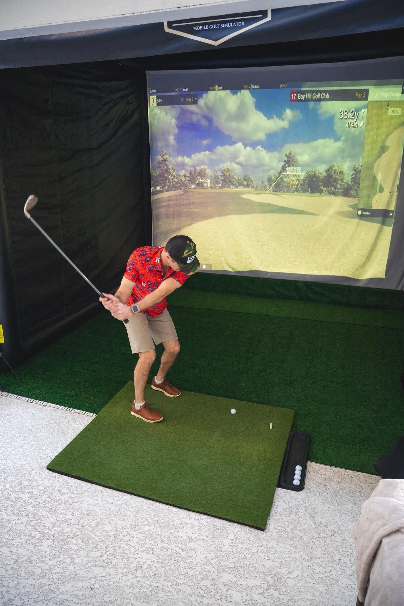 Guest taking a swing on the Sun City Swing simulator